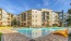 Pool lounge at our apartments for rent in Northeast Dallas, TX, featuring beach chairs and a view of the apartment exterior.