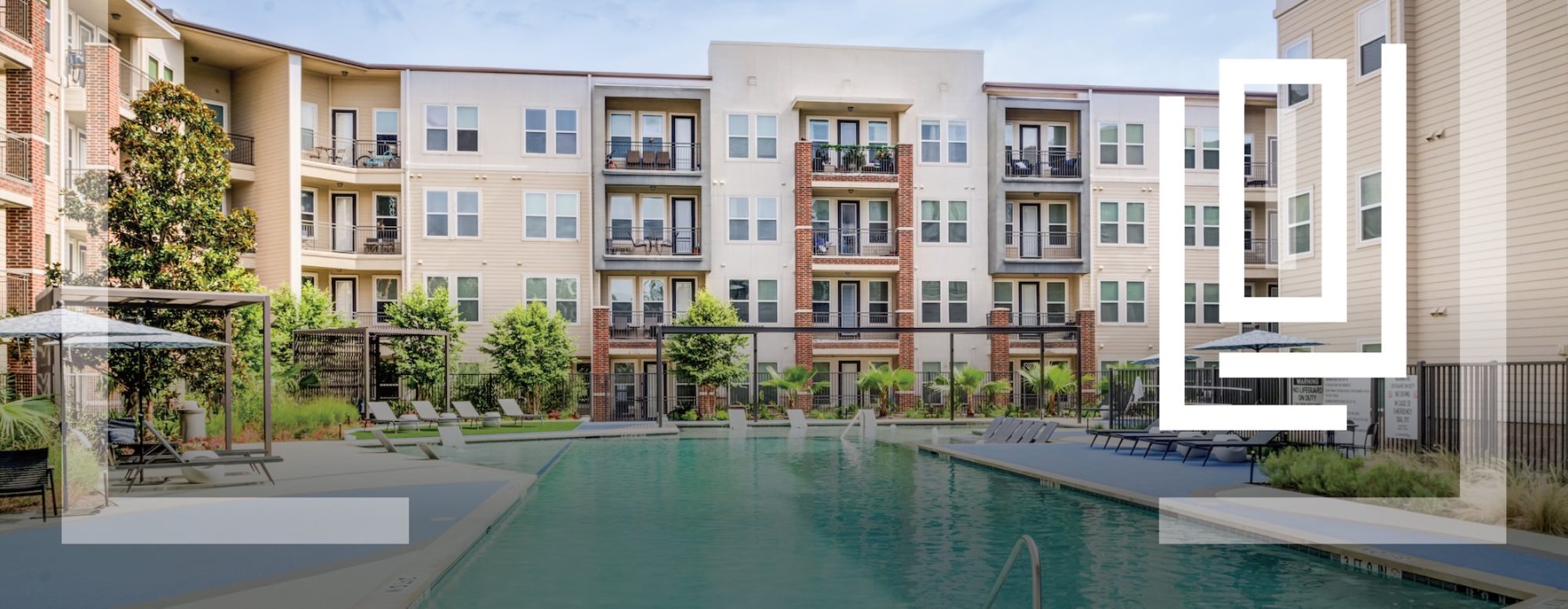 resort style pool with seating and a building behind