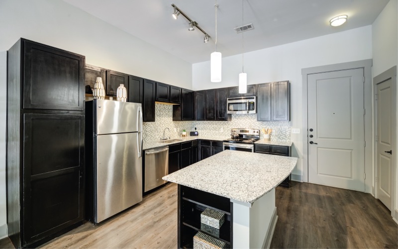 kitchen with black cabinets and stainless steel appliances