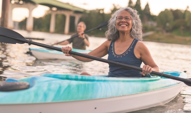 a person kayaking on a body of water