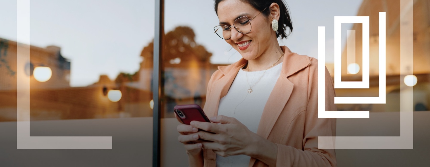 a person smiling while looking at a phone